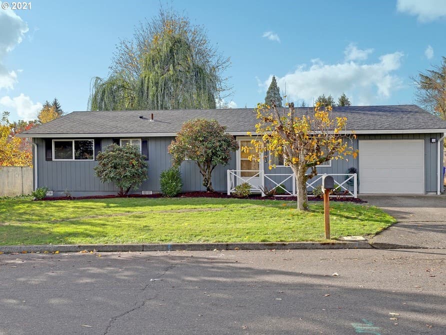69th Court — a single-story grey ranch home with a garage and a wide front lawn on a quiet Milwaukie street