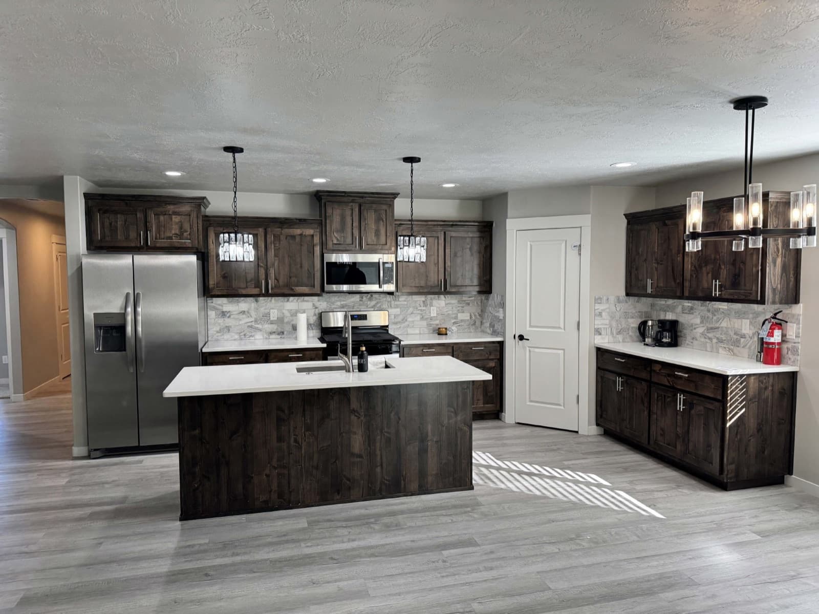 Kitchen with a large island, quartz counters, and stainless appliances